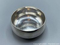 Top front view showing the polished silver electroplated finish inside and outside the small bowl, highlighting the rounded form.