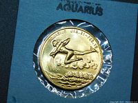 Front side of the Aquarius zodiac coin showing the relief image of water-bearer figure with birth date range JAN. 21 - FEB. 19