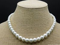 Single strand white pearl necklace displayed on a fabric bust stand showing graduated pearl sizes.