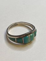 Sterling silver turquoise ring showing the stones and band from the side angle.