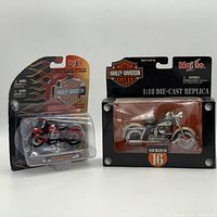 Two Harley-Davidson die-cast replica motorcycles in original packaging by Maisto, showing both bikes side by side.