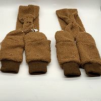 Photo showing two sets of brown boucle headwrap and mittens, each set includes one headwrap and a pair of mittens.