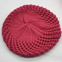 Top view of a single pink yarrow BP Nordstrom knit beret hat showing solid knit center and open knit pattern body.