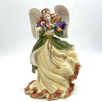 Front view of Royal Doulton Angel Of Autumn figurine with detailed wings, flowing dress, and colorful garland.
