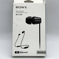 Front view of the original product box showing the Sony branding, model WI-C310, image of the black wireless stereo headset, Bluetooth and battery life icons.