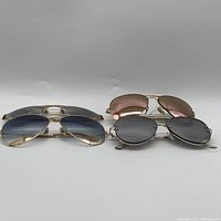 Front view of four sunglasses showing frames and lens colors