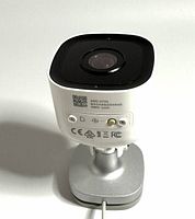 Front view of the outdoor Wi-Fi camera showing lens and QR code label.