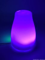 Frosted glass diffuser glowing purple lighting in dark environment to showcase 7 color LED lights.