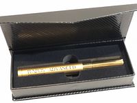 Closed gold metallic LUXROS Advanced Eyebrow Boost Serum tube in black presentation box