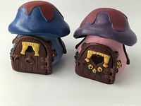 Back view showing mushroom-shaped roofs and front doors with windows and curtains.