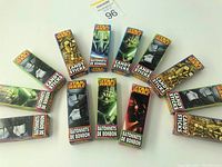 Top view of 12 unopened Star Wars candy stick boxes arranged in a semi-circle showing front character artwork and branding.