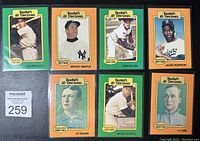 Photo showing 8 baseball cards in a grid layout, featuring Joe DiMaggio, Mickey Mantle, Bob Feller, Jackie Robinson, CY Young, and Ty Cobb cards.