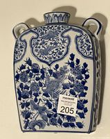 Full view of the blue and white Chinese porcelain vase showing its front detailed decoration including floral and birds.
