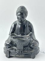 Front view of vintage Japanese Buddha spelter incense burner showing detailed facial features, textured hair, and the bowl for incense.