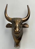 Front view of the bronze-colored bull head bust statue depicting Egyptian god of strength with detailed horns and carved patterns.