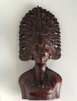 Front view of the wooden bust showing detailed face and carved crown headdress