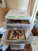 Plastic storage drawers with multiple hooked wool mats visible