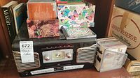 Front view of TEAC stereo radio with CD player showing retro design and included CDs in background.