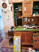Overall view of the wooden cabinet with open door showing vintage camera, tripod inside cupboard and boxed Barwood '80' slide editor leaning on cabinet.