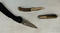 All three folding hunting knives seen from above