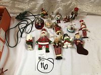 Overview photo of all 13 vintage German hand-painted Christmas ornaments on a table, showcasing variety and condition.