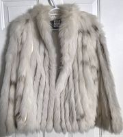 Front view of the women's white fur coat showing soft and fluffy texture with natural light brown markings.