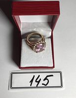 Gold plated ring with pink crystal center and clear crystal halo in red box showing front view.