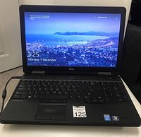 Front view, laptop powered on showing desktop