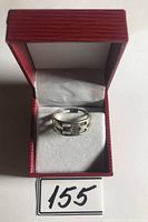 Front view of sterling silver linked design ring in red jewelry box