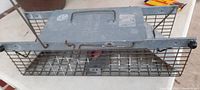 Top view showing the solid steel top plate with handle and embossed 'HAVAHART LITITZ PA' branding, cage doors and metal wire mesh sides visible.