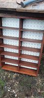 Full view of the farmhouse display shelf unit showing multiple shelves and rustic wood framing with dovetailed construction