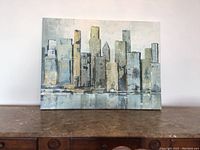 Full front view of the rectangular canvas painting showing abstract city skyline in neutral colors.