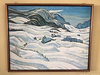 Framed art print of a snowy landscape with mountains and houses, showing overall view.
