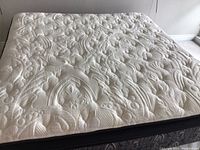 Full view of quilted Kingsdown Hayworth mattress top with intricate floral and geometric stitching patterns