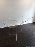 Front angle view of console table showing clear glass top and acrylic base