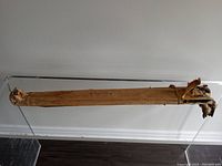 Photo showing the full length of one hairpin table leg wrapped in old brown paper.
