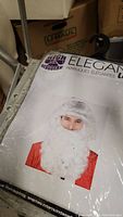 Packaging for Santa wig and beard combo showing white beard and hair, labeled High Quality Disguise Elegant