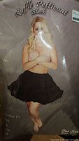 Photo of black ruffle petticoat packaging showing a model wearing the petticoat.