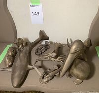 Group photo of the brass animal figurines gathered on a chair, showing approximate size and overall appearance.