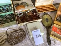 Overall lot view showing jewelry boxes, beaded handbags, hair accessories, hand mirror
