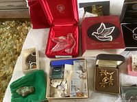 Grouped shot of jewelry boxes, rings and small stones