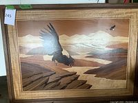 Full framed wood inlaid art showing eagle in flight over landscape with mountains and river.