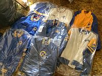 Overall lot of six ladies XL Los Angeles Rams jackets and coats in plastic covers on carpet