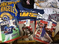 Overview of Rams sweaters, NFL Gameday magazines and hats on display