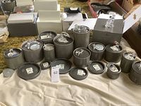 Wide shot of all round tin containers with crystal animal figurines displayed