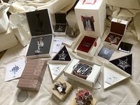 Seven-item lot displayed including Swarovski figurines, ornament, trinket box and stone carvings