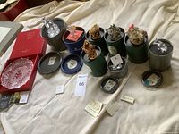 Overview of all items: plate in box, crystal figurines in tins, resin trinket boxes in tins