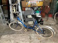 Side view of the Pony folding bike showing frame, seat, wheels, pedals, and rear rack.