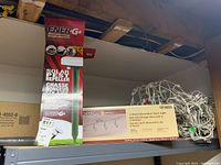 Photo showing the boxed EnerG+ solar pest repeller stakes and Portfolio boxed decorative track light.