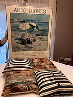 Full view of framed Aldo Luongo beach print with four decorative throw pillows in front